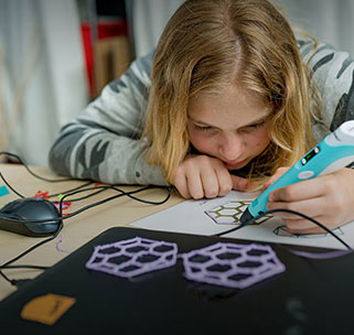 Teen using a 3d printer pen to create a geometric pattern