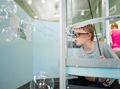 Child experimenting with air and bubbles